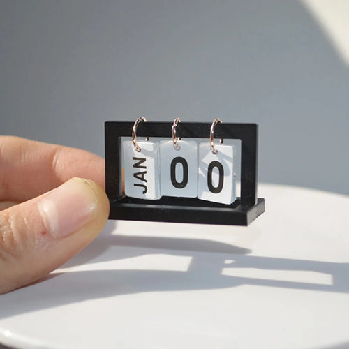 Miniature wooden desk calendar for dollhouse, detailed LOY Home Decor dollhouse accessory with tiny date displays and realistic design.